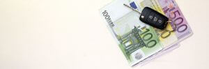 Euro banknotes and new car keys.Conceptual image for finance or business.Lot of copy space